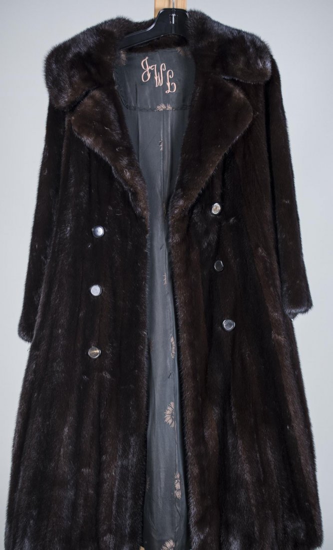 Lady's 3/4 Length Mink Coat: Mahogany color, mink rope belt, male pelts. Has been stored regularly at Saks. Size small. Length 44 inches.