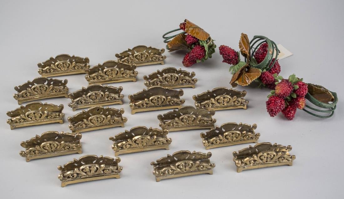 Seventeen Brass Card Holders: Scroll decoration, together with three strawberry napkin rings.