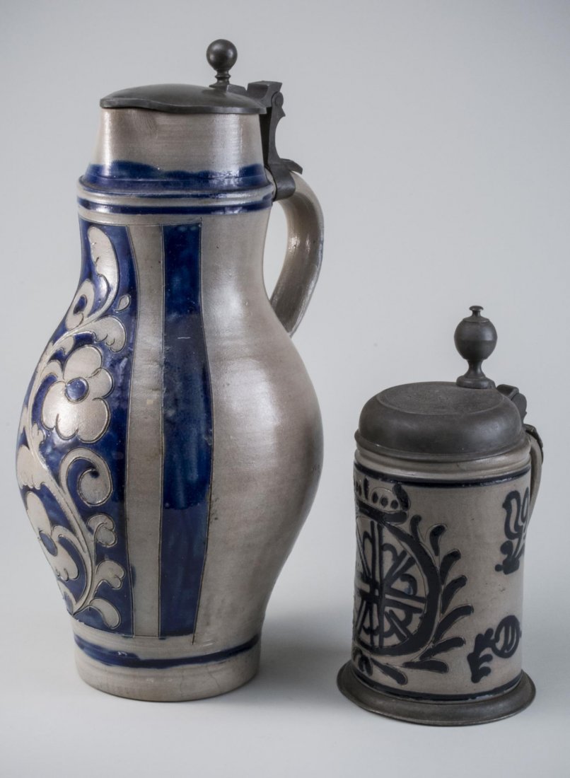 Two Ironstone Steins: Each with cobalt floral decoration. Taller height 14 1/2 inches.