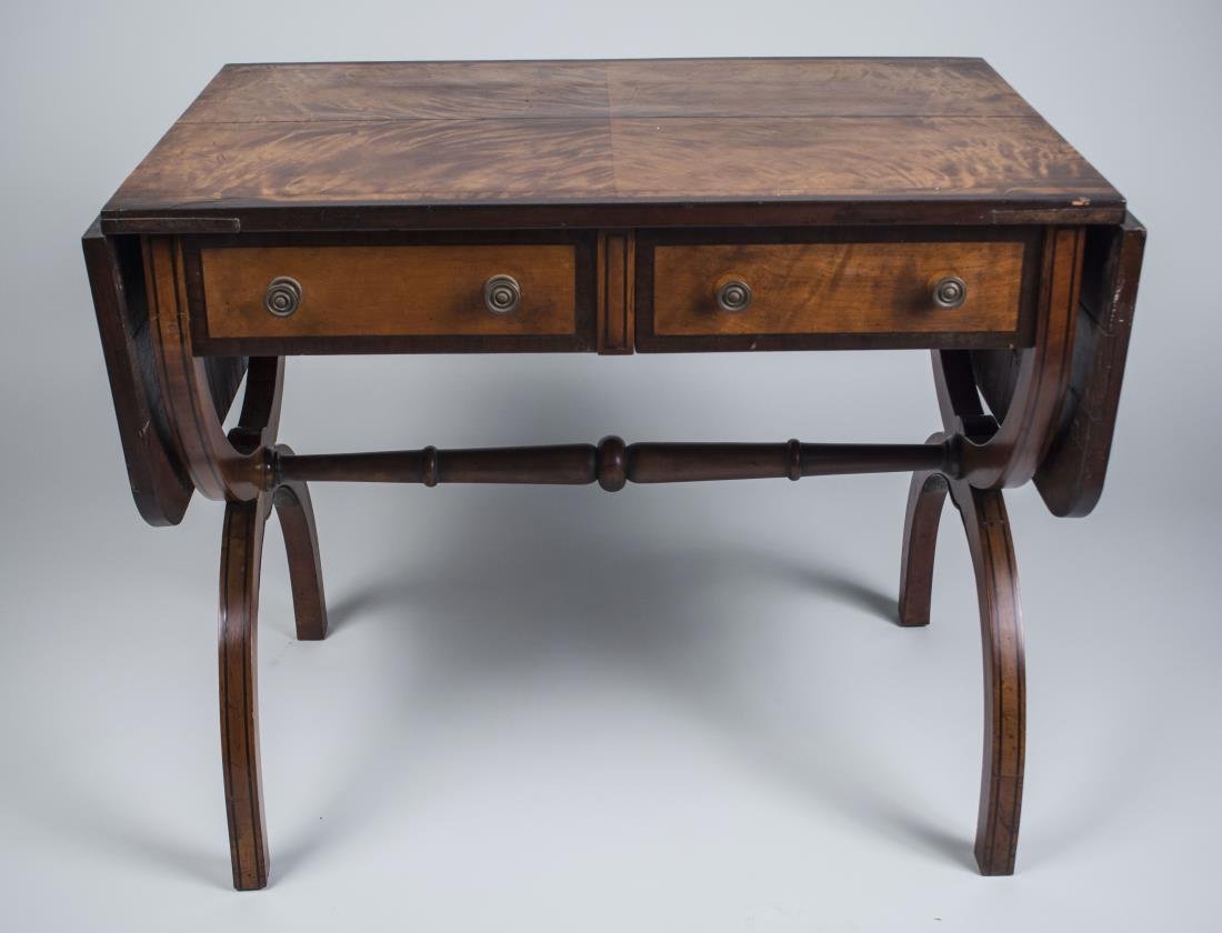 Victorian Satinwood & Mahogany Sofa Table: Early 19th century, rectangular crossbanded top with two drop leaves, over two opposite drawers and two false drawers, on a curule trestle base. Height 28 inches, width extended 58 inches, depth 23 in