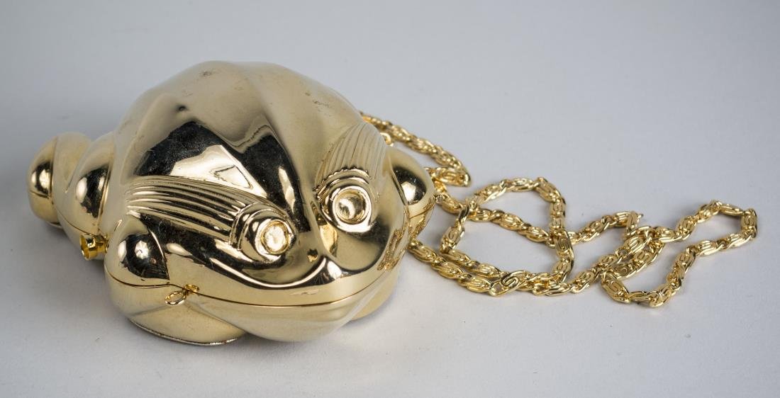 Judith Leiber Gold Tone Purse: In the form of a frog, includes shoulder chain. Measures 5 inches long. Notice to bidders: Condition reports and additional photographs are provided by request as a courtesy to our clients, as such an