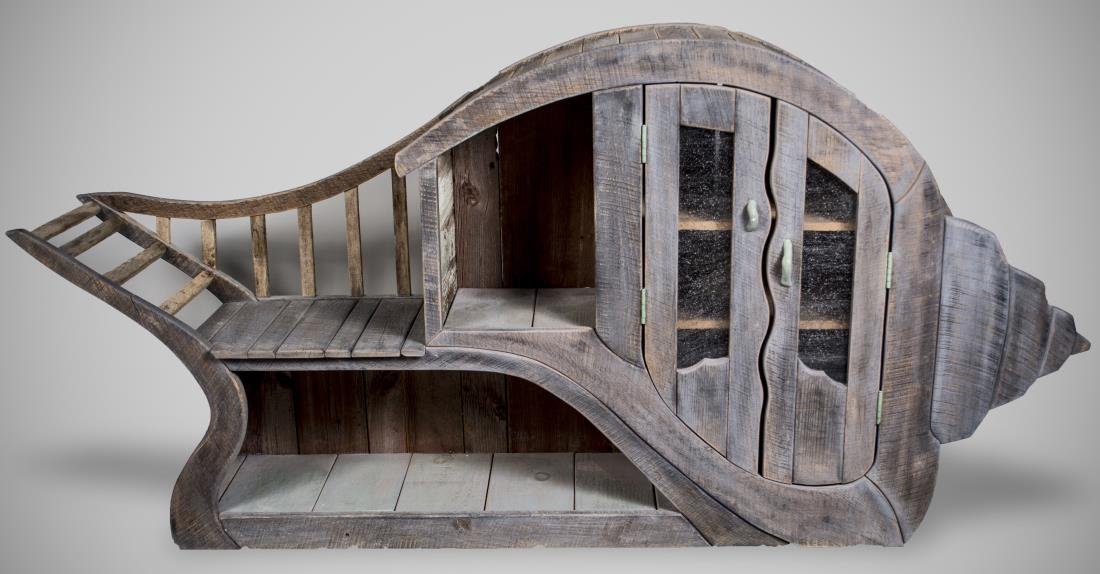 Ted Box Conch Cabinet: Conch shaped natural drift wood cabinet with two doors opening to two shelves and two separate open shelves. Height 39 inches, width 5 feet 10 inches, depth 15 inches. Notice to bidders: Condition rep