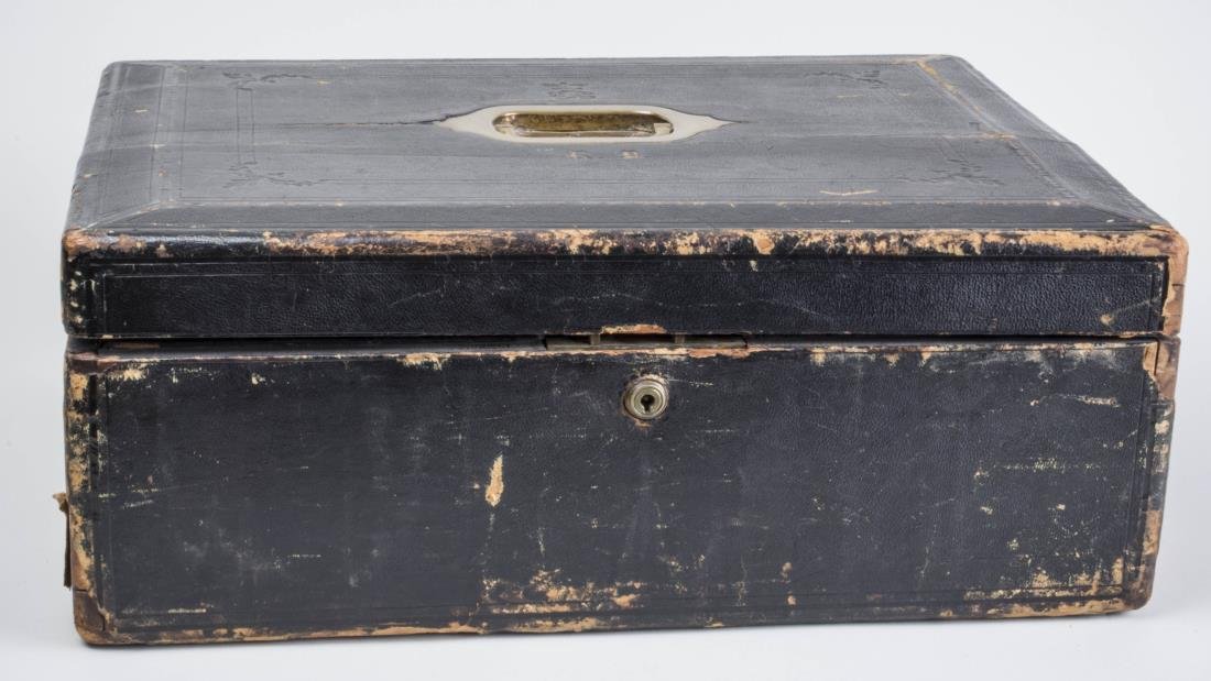 Leather Lap Desk: Blue painted leather case opening to a fitted interior. Height 8 inches, width 20 1/2 inches, depth 16 inches. Notice to bidders: Condition reports and additional photographs are provided by request a