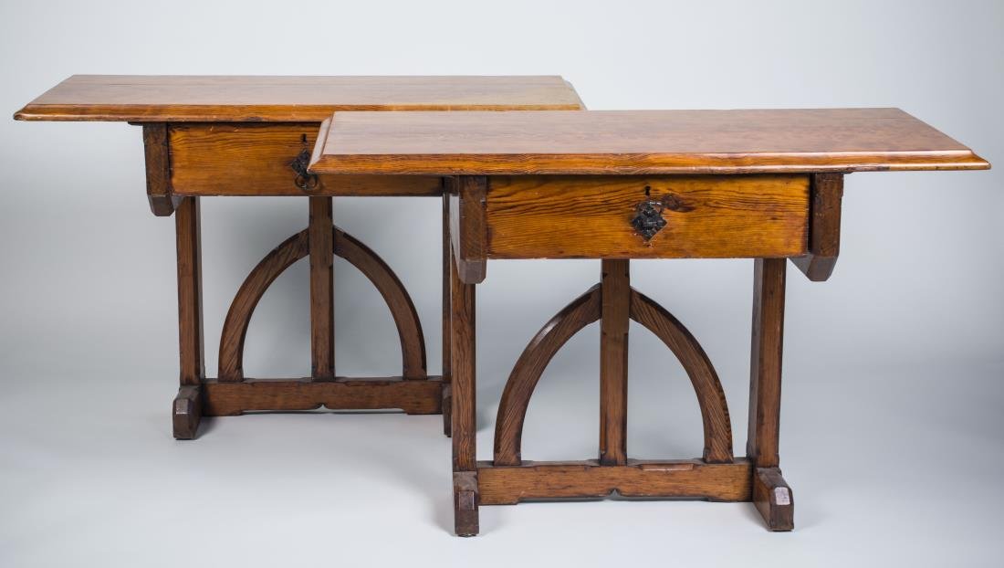 Pair of Fruitwood Console Tables: Each with rectangular top over a single drawer, on a gothic arch designed trestle base. Height 29 inches, width 41 inches, depth 19 inches. Notice to bidders: Condition reports and additional photogra