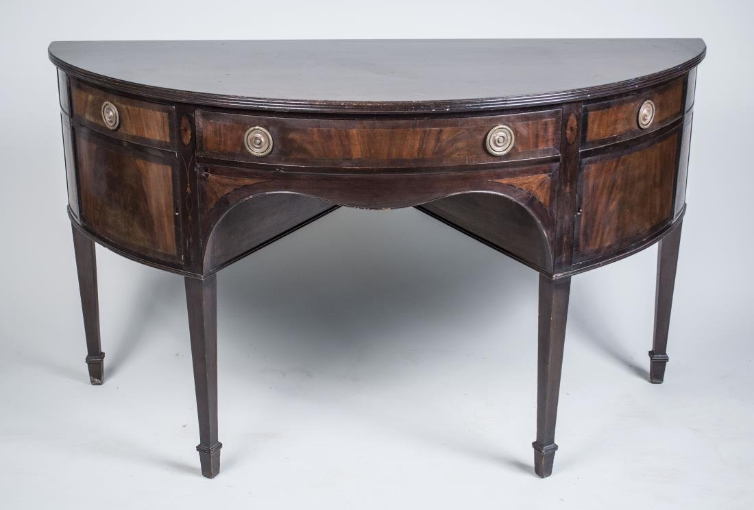 Mahogany Sideboard: Demilune top over a center drawer flanked by two cabinets, on square tapered legs. Height 35 inches, width 60 inches, depth 25 inches. Notice to bidders: Condition reports and additional photographs a