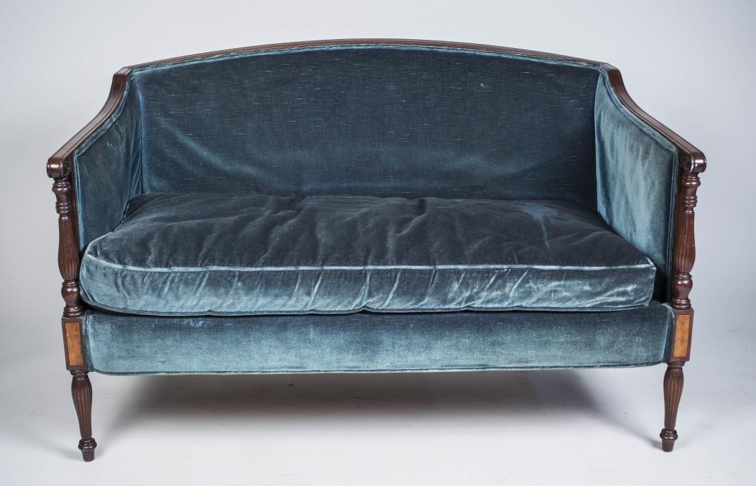 Blue Velvet Upholstered Mahogany Settee: Slightly arched back, downscrolled arms on turned supports, down filled cushion, turned legs. Height 34 inches, width 51 inches, depth 31 inches. Notice to bidders: Condition reports and additional ph