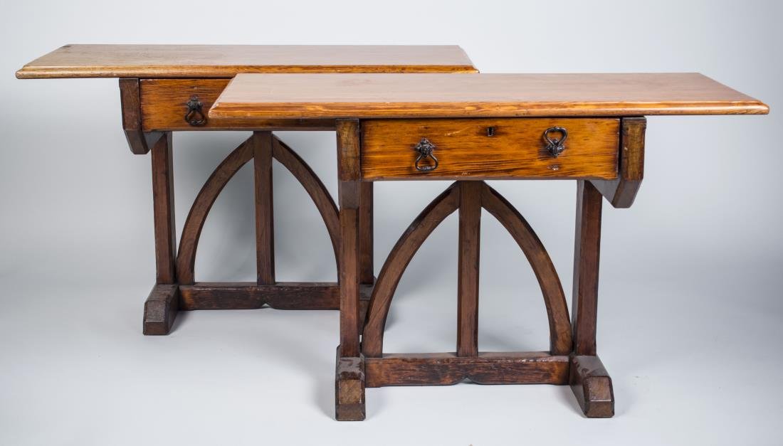 Pair of Fruitwood Console Tables: Each with rectangular top over a single drawer, on a gothic arch designed trestle base. Height 29 inches, width 41 inches, depth 19 inches. Notice to bidders: Condition reports and additional photogra