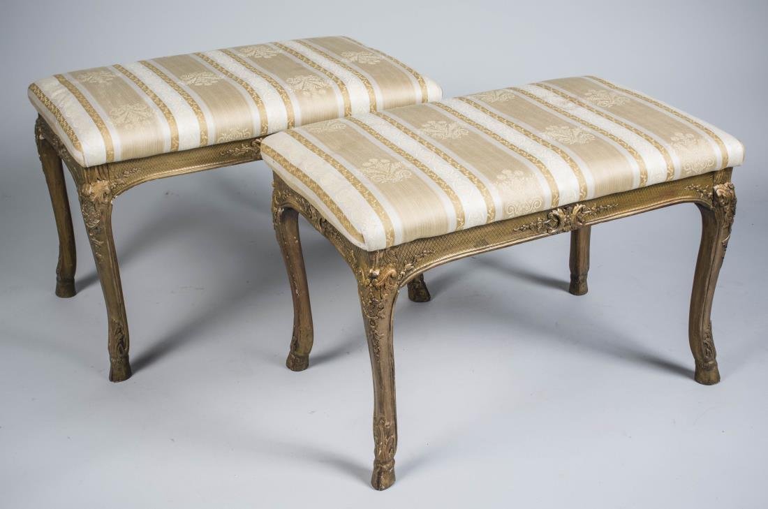 Pair of Louis XV Style Gilt Wood Benches: Each with upholstered seat, on cabriole legs ending in hoof feet. Height 30 inches, width 30 inches, depth 18 inches. Notice to bidders: Condition reports and additional photographs are provided by re