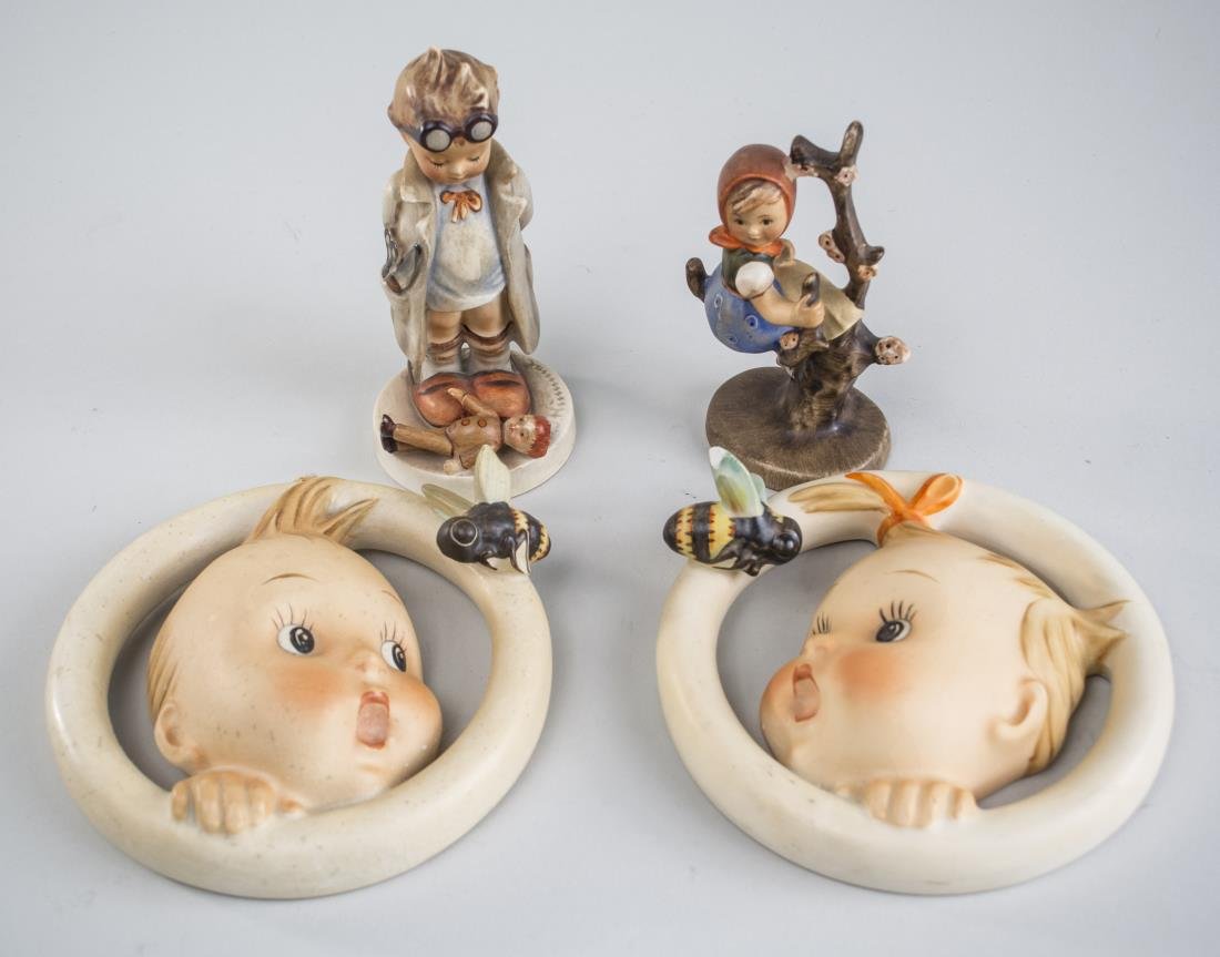 Group of Four Hummels: Comprising a figure of a girl sitting on a branch, a figure of a boy wearing a long coat and goggles, and a pair of ornaments depicting a boy and a girl, all with the blue bee mark. Ornament diameter 
