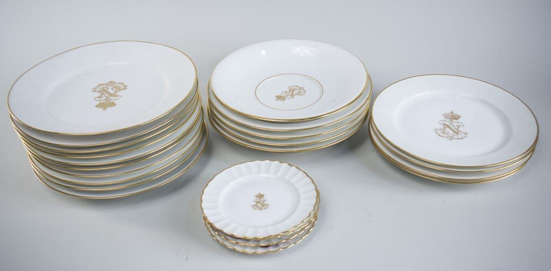 Sevres Porcelain Service: Gilt rim and Napoleonic center medallion, comprising ten dinner plates, four salad plates, four soup plates, four bread plates, and a bowls. Dinner plate diameter 9 1/2 inches. Notice to bidders: Cond