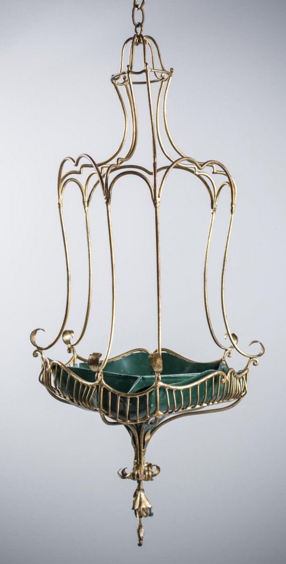 Gilt Metal Lantern Form Hanging Planter: Gilt metal cage with a green painted three part segmented tole jardiniere base. Height 24 inches. Notice to bidders: Condition reports and additional photographs are provided by request as a courtesy