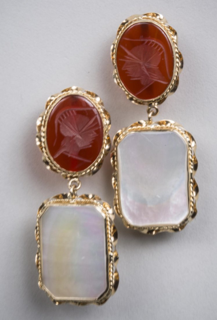 Carnelian and Mother of Pearl Earrings: 14k yellow gold earrings, intaglio oval carnelian suspending a mother of pearl plaque. Length 2 inches. Notice to bidders: Condition reports and additional photographs are provided by request as a cou