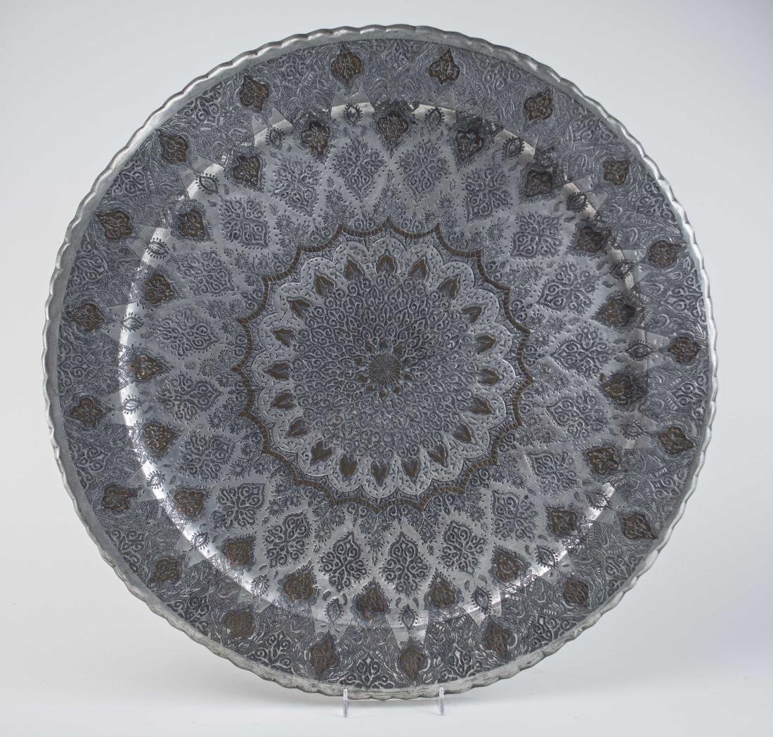 Middle Eastern Metal Charger: Elaborate raised decoration. Diameter 22 inches. Notice to bidders: Condition reports and additional photographs are provided by request as a courtesy to our clients, as such any condition report is o
