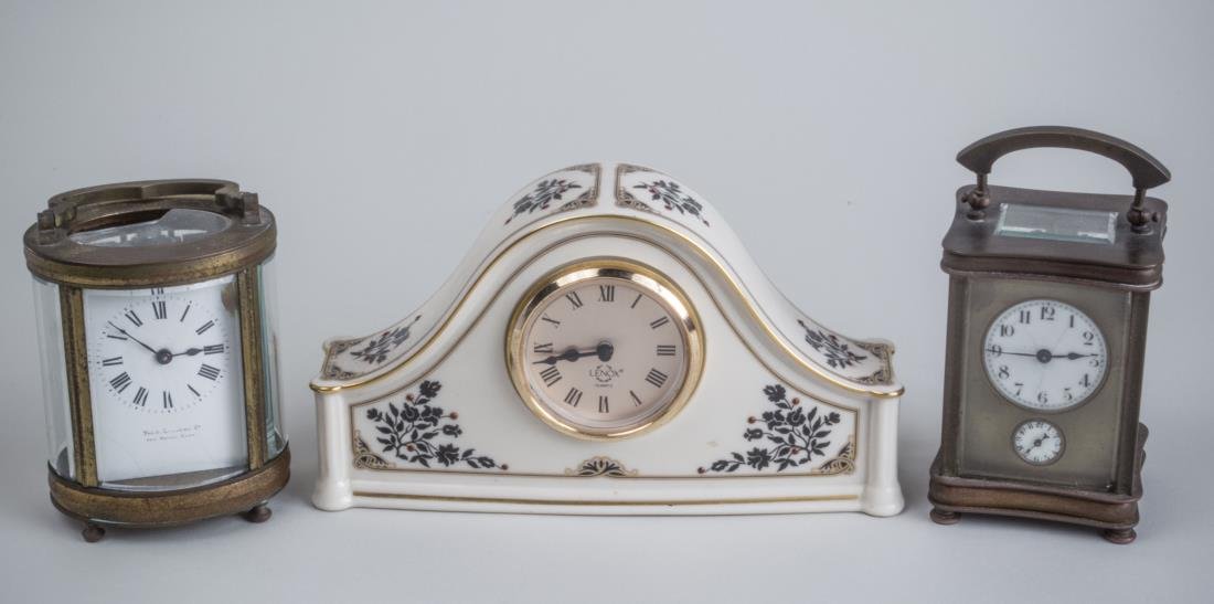Three Table Clocks: Two carriage clocks, one with alarm and a ceramic desk clock. Ceramic clock, height 5 inches. Notice to bidders: Condition reports and additional photographs are provided by request as a courtesy to o