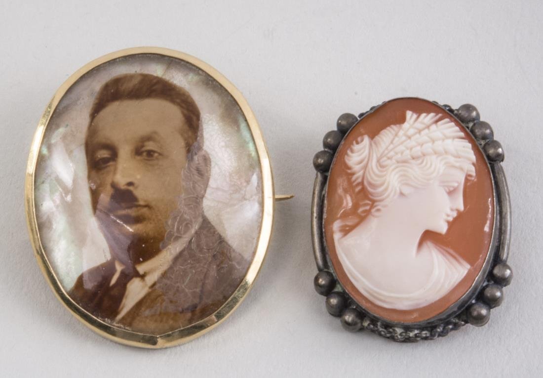 Portrait Pin and Italian Shell Cameo Brooch: 800 silver mounted shell cameo and a gold filled portrait locket brooch. Portrait pin, 1 3/8 x 1 inch. Notice to bidders: Condition reports and additional photographs are provided by request as a cour
