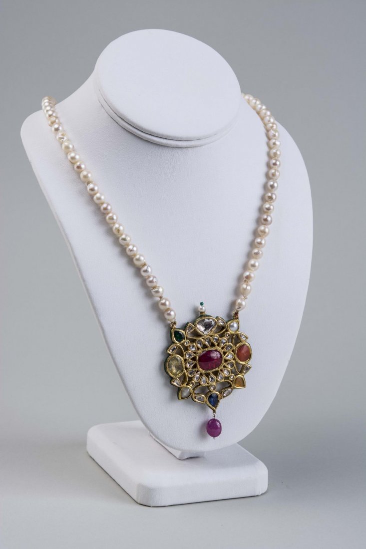 High Carat Mughal Style Filigree Pendant Necklace*: Cultural pearl necklace with eighty-nine pearls measuring 4.0-4.5mm and suspending a 22k gold pendant with flat cut and rose cut diamonds and blue and yellow sapphires and emeralds, elaborate enamel d