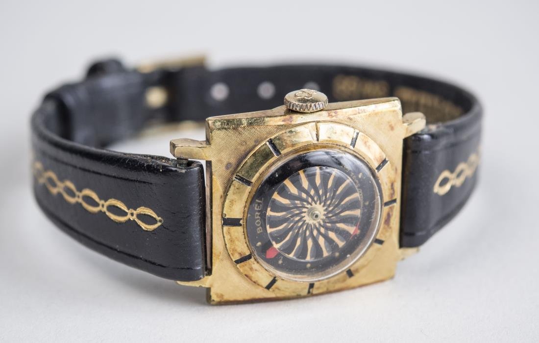 Ernest Borel 'Kaleidoscope' Cocktail Watch: Gold plated watch with black leather band. Notice to bidders: Condition reports and additional photographs are provided by request as a courtesy to our clients, as such any condition report is only an