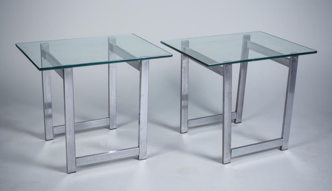Pair of Chrome Glass Top Tables: Each with rectangular glass top, on a chromed base. Height 20 inches, width 24 inches, depth 18 inches. Notice to bidders: Condition reports and additional photographs are provided by request as a cou