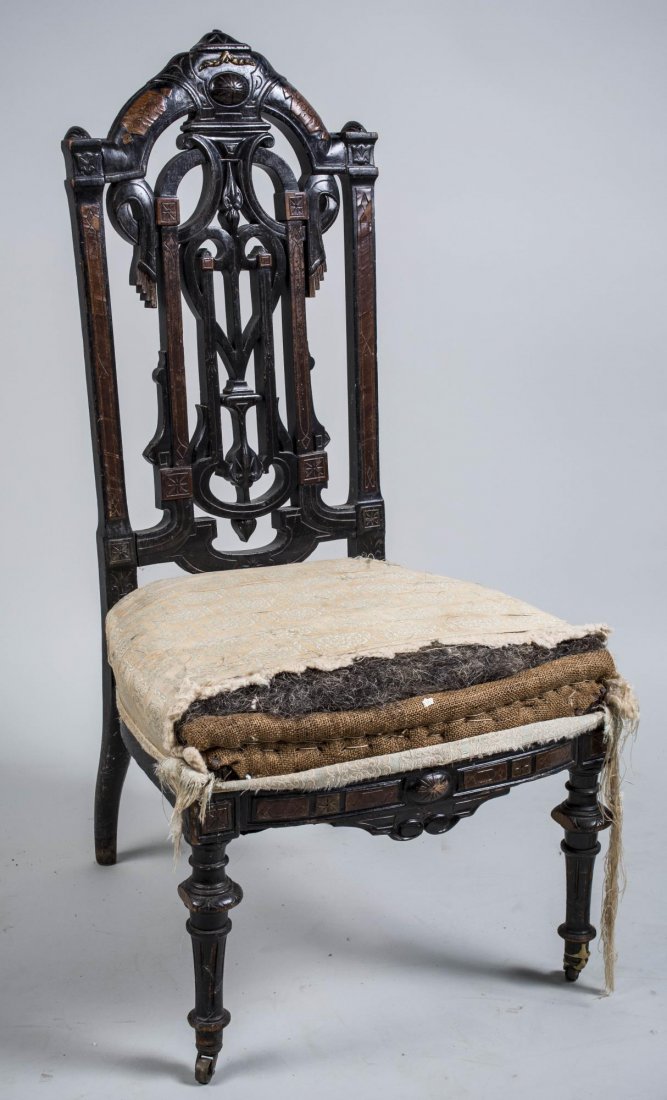 Renaissance Revival Style Walnut Slipper Chair: Openwork back, upholstered seat, turned front legs ending a brass casters. Height 40 inches, width 20 inches, depth 20 inches. Notice to bidders: Condition reports and additional photographs are provi
