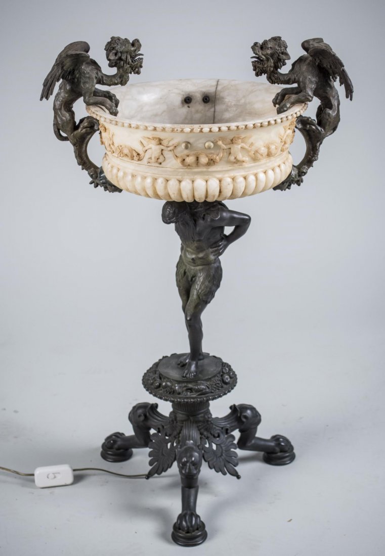 Alabaster Floor Lamp / Flower Stand: Renaissance Revival style alabaster bowl mounted with two griffins and electrified, on a figural support with tripod base with animal paw feet. Height on griffins, 36 inches. Notice to bidders: Condit