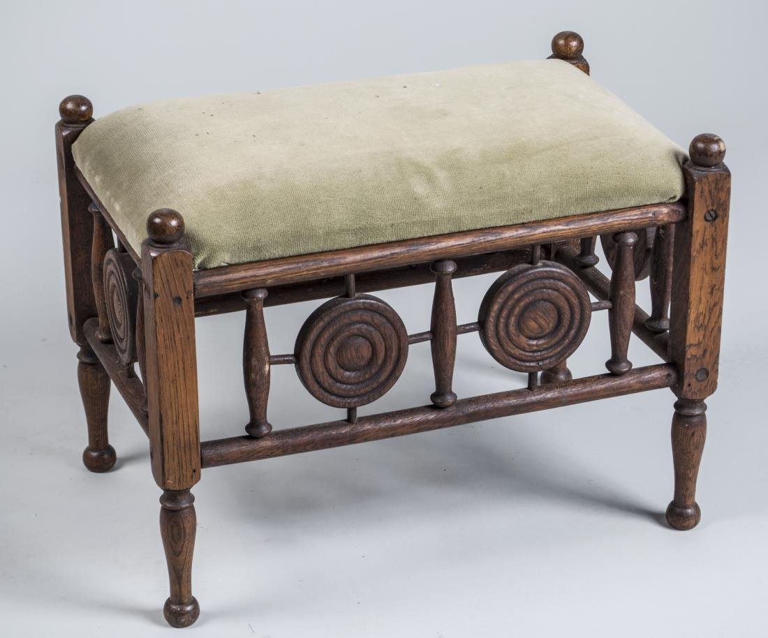 Aesthetic Style Upholstered Footstool: Upholstered cushion top on block and turned legs. Height 15 inches, width 20 inches, deoth 12 inches. Notice to bidders: Condition reports and additional photographs are provided by request as a court