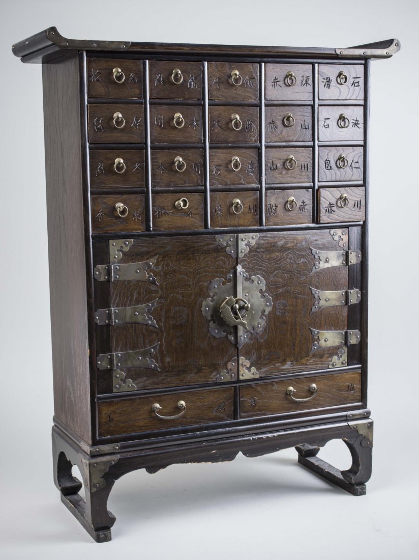 Korean Apothecary Cabinet: Rectangular top with upturned ends, over four rows of five drawer above a two door cabinet and two lower drawers. .Height 31 inches, width 24 inches, depth 9 inches. Notice to bidders: Condition repor