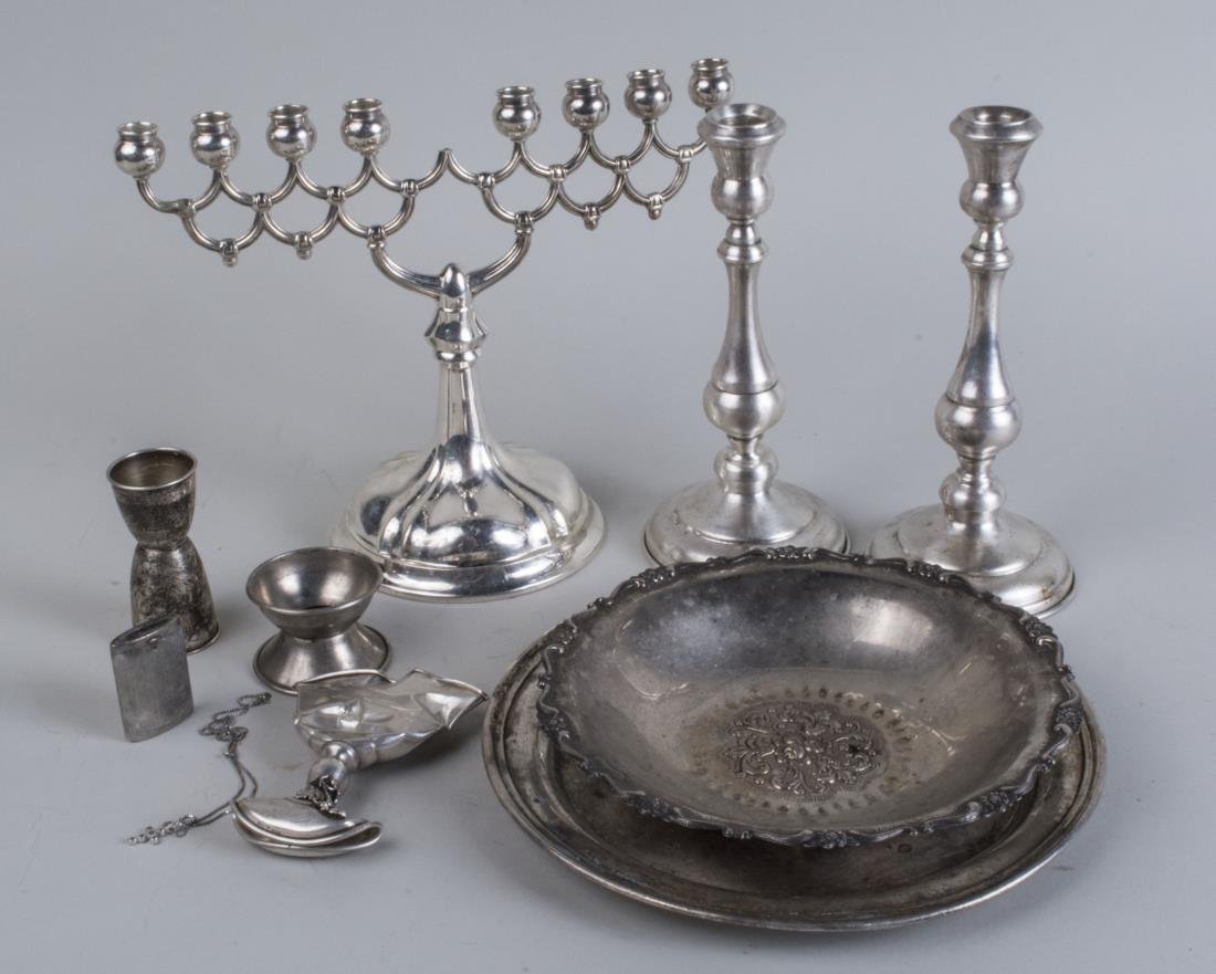 Group of Silver and Silver Plated Articles: Including pair of candlesticks; a German .835 silver menorah, weighted; a bowl, a plate, cup, a Gorhan sterling silver jigger, a matchsafe, a neck chain chain, etc. Notice to bidders: Condition report