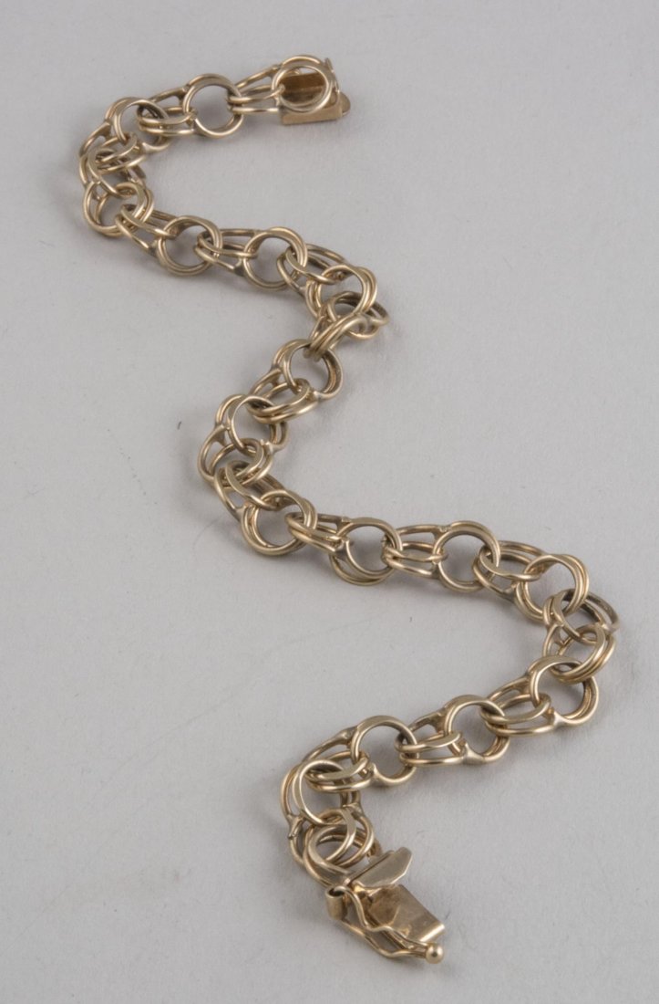 Gold Chain Bracelet *: 14k yellow gold, double ring links. Length 7 1/4 inches. 8.2 grams. Notice to bidders: Condition reports and additional photographs are provided by request as a courtesy to our clients, as such any co