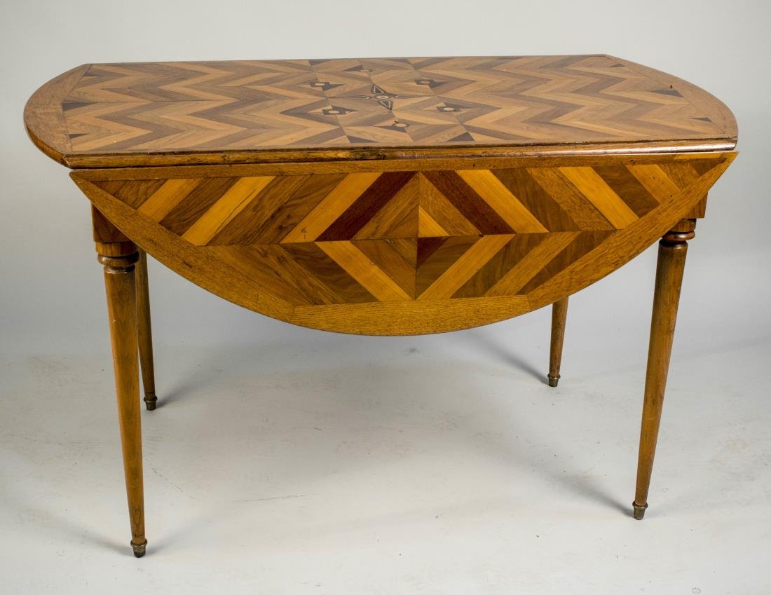 Parquetry Drop Leaf Table: Rectangular parquetry inlaid top flanked by two drop leaves, on turned tapered legs. Height 28 inches, width 45 inches, depth 24 inches. Notice to bidders: Condition reports and additional photographs