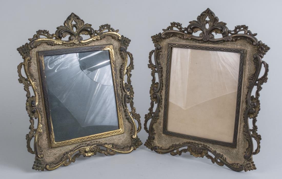 Pair of Bronze Picture Frames: Each with floral and scroll decoration. 14 1/2 x 12 inches. Notice to bidders: Condition reports and additional photographs are provided by request as a courtesy to our clients, as such any condition 