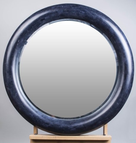 Karl Springer Style Mirror: Circular with black simulated wood frame. Diameter 37 inches. Notice to bidders: Condition reports and additional photographs are provided by request as a courtesy to our clients, as such any conditio