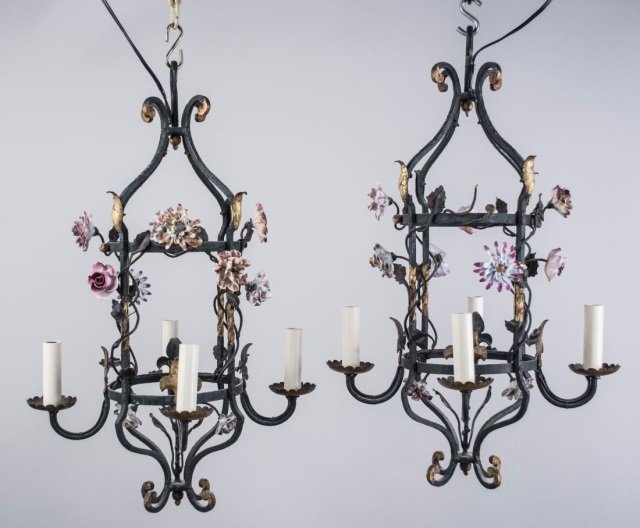 Pair of Iron and Ceramic Flower Chandeliers: Each a four light hanging fixture with polychrome ceramic flowers. Height 22 inches, width 14 inches. Notice to bidders: Condition reports and additional photographs are provided by request as a court