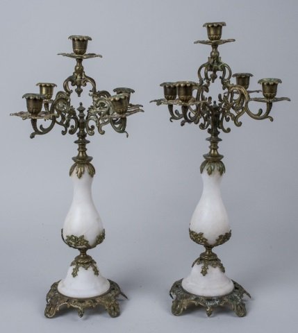 Pair of Brass and Alabaster Candelabra: Five light brass arms on a white marble baluster form support. Height 17 1/2 inches. Notice to bidders: Condition reports and additional photographs are provided by request as a courtesy to our client