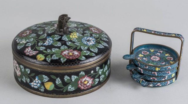 Two Chinese Cloisonne Articles: Set of four coasters and matching stand and a circular covered box, both with floral decoration. Box height 4 1/2 inches, diameter 7 inches. Notice to bidders: Condition reports and additional photogr