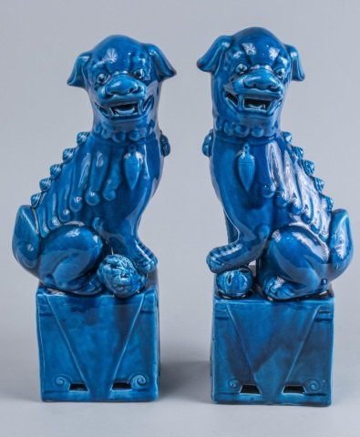 Pair of Chinese Porcelain Foo Dogs: Turquoise glaze. Height 14 1/2 inches. Notice to bidders: Condition reports and additional photographs are provided by request as a courtesy to our clients, as such any condition report is only an opi