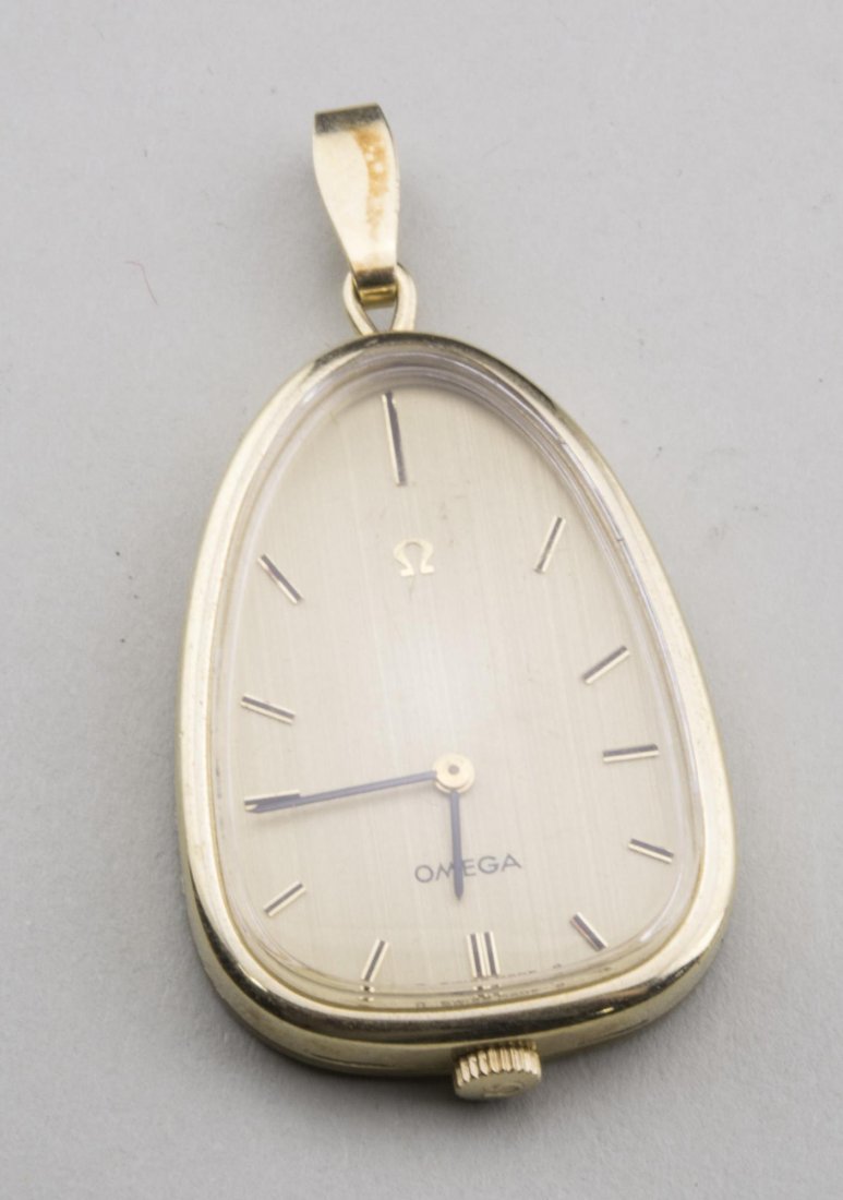 Omega Pendant Watch: 14k yellow gold pendant watch with baton hours. 1 1/2 x 1 inch. Notice to bidders: Condition reports and additional photographs are provided by request as a courtesy to our clients, as such any condit