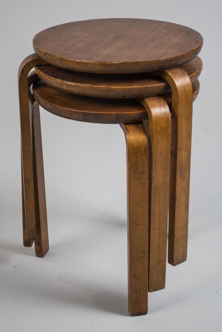 Alvar Aalto Nest of Three Tables: Circular tops on bent wood legs. Height 21 inches, diameter 14 inches. Notice to bidders: Condition reports and additional photographs are provided by request as a courtesy to our clients, as such any