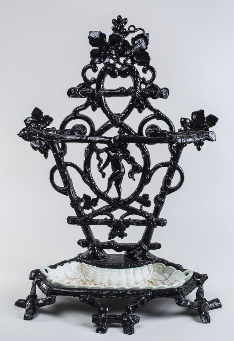 Neoclassical Style Umbrella Stand: Painted cast iron with ceramic insert, fruiting vine decoration. Height 28 1/2 inches. Notice to bidders: Condition reports and additional photographs are provided by request as a courtesy to our clie