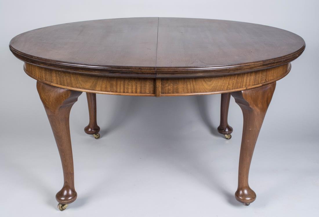Queen Anne Style Fruitwood Dining Table: Oval extension top on cabriole legs ending in pad feet, with two leaves. Closed. Height 29 inches, width 55 inches, depth 48 inches. Notice to bidders: Condition reports and additional photographs are
