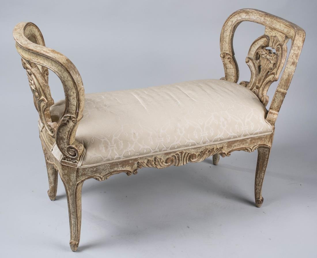 Painted Window Bench: Cream painted bench with ivory fabric upholstered seat. Height 28 inches, width 40 inches, depth 17 inches. Notice to bidders: Condition reports and additional photographs are provided by request as a