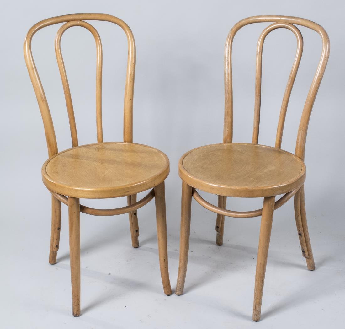 Pair of Thonet Side Chairs: Bent wood backs, circular seats. Height 35 inches, width 16 inches, depth 17 inches. Notice to bidders: Condition reports and additional photographs are provided by request as a courtesy to our client