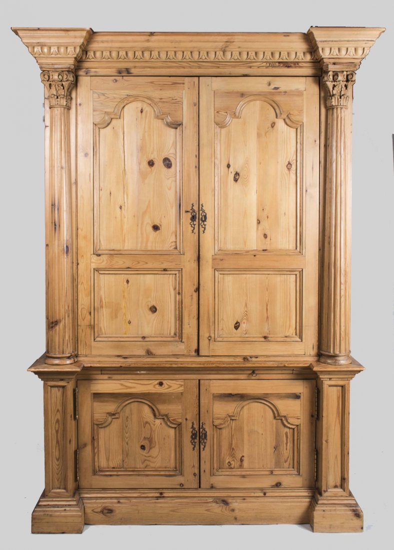 Pine China Cabinet: Breakfronted cornice with thumb and dart molding over two pairs of paneled doors, flanked by fluted columns, conforming plinth base. Height 7 feet 7 inches, width 59 inches, depth 29 inches. Notice to