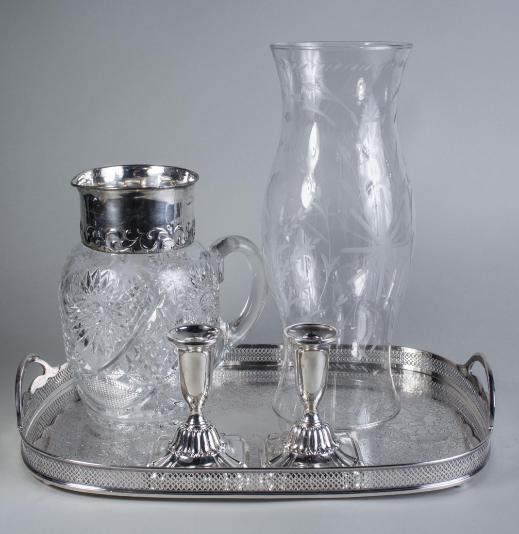 Three Silver Plated Table Articles: Comprising a Sheffield two-handle galleried serving tray, a pair of Towle sterling silver candlesticks, weighted and a silver plated mounted cut glass pitcher. Pitcher, height 9 1/4 inches. Notice to 
