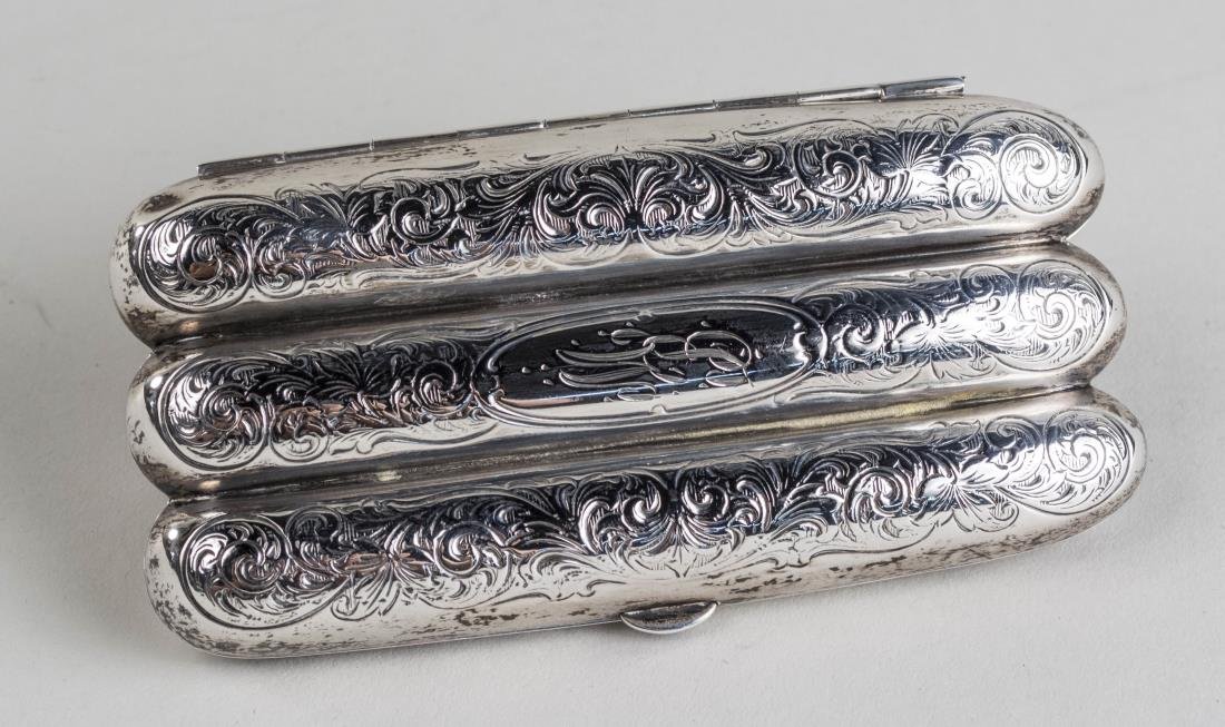 Sterling Silver Cigar Case: Leafy scroll decoration, holds three cigars, monogrammed MB. 5 x 2 1/2 inches, 76 grams. Notice to bidders: Condition reports and additional photographs are provided by request as a courtesy to our cl