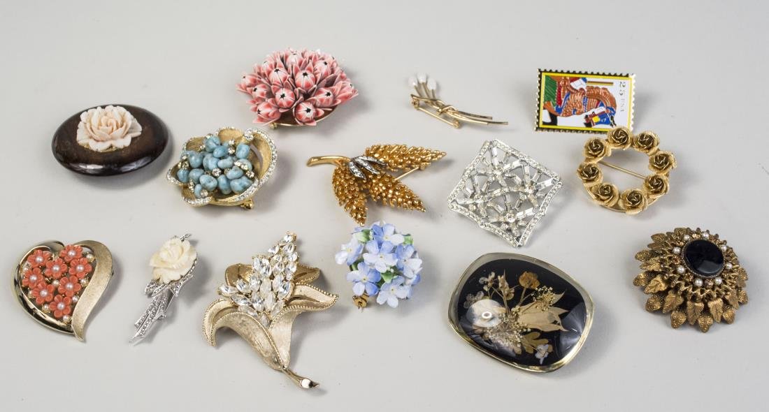 Group of Flower Brooches: Including two Trifari brooches, an English blue enamel flower brooch, gold tone circle brooch, etc. Notice to bidders: Condition reports and additional photographs are provided by request as a courtes