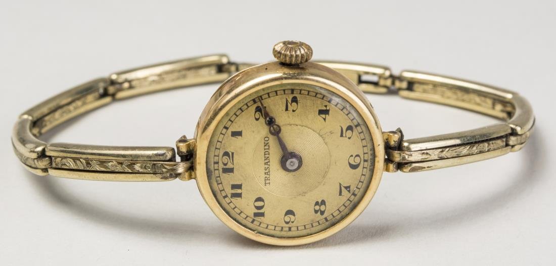 Lady's Gold Swiss Wristwatch: 18k yellow gold watch, dial signed Trasandino, with Arabic numerals, gold filled band. Notice to bidders: Condition reports and additional photographs are provided by request as a courtesy to our clie