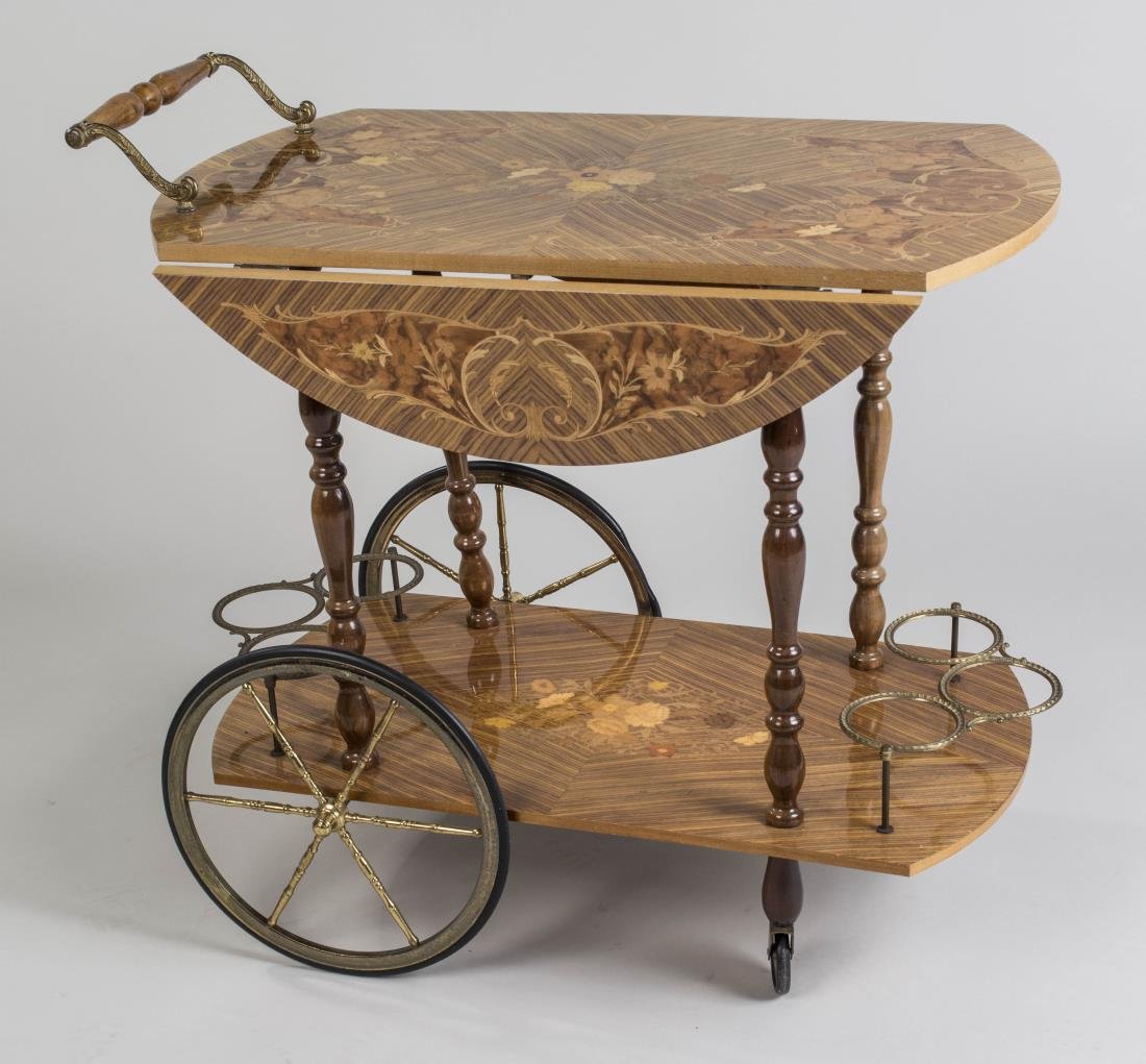 Italian Marquetry Inlaid Tea Cart: Two-tier cart with floral marquetry decoration and two drop leaves, lower shelf with two metal wine bottle racks. Closed. Height 30 inches, width 32 inches, depth 19 inches. Notice to bidders: Conditi