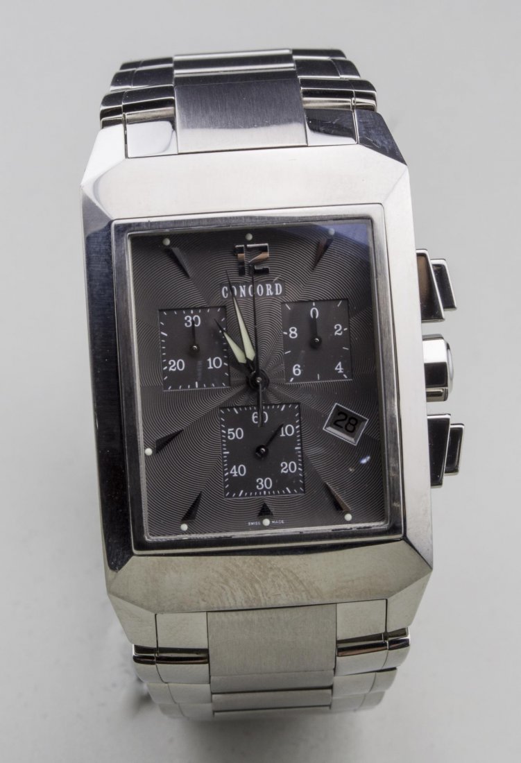 Concord Man's Watch: Metal dial with baton hours, three subsidiary dials and date aperture, no. 1276025, stainless steel band. Notice to bidders: Condition reports and additional photographs are provided by request as a c