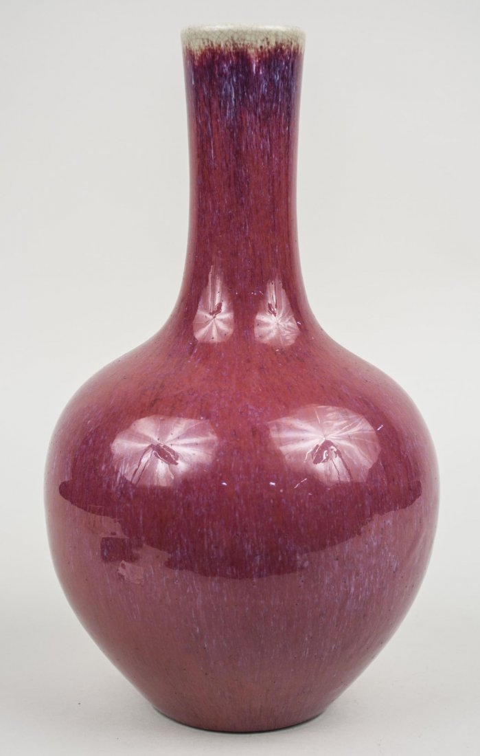 Chinese Porcelain Vase: Bottle form, sang de boeuf glaze. Height, 15 inches. Provenance: From the Collection of Erwin A. Raible Notice to bidders: Condition reports and additional photographs are provided by request as a cou
