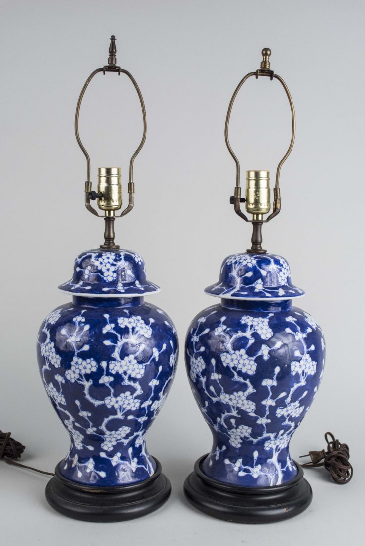 Pair of Chinese Porcelain Ginger Jar Lamps: Single light lamps with allover blue and white decoration of blossoms. Height 18 1/2 inches. Notice to bidders: Condition reports and additional photographs are provided by request as a courtesy to ou